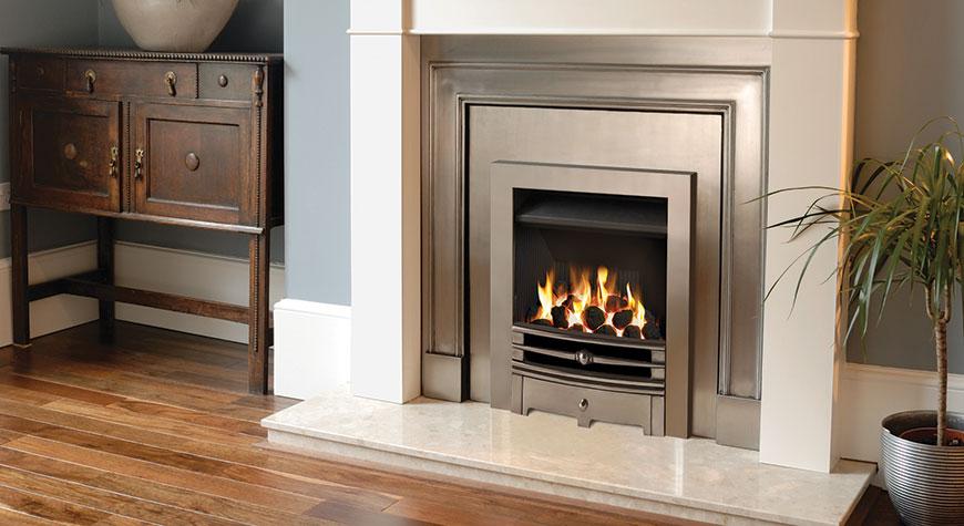 Belgravia polished cast front with polished insert panel. Shown with Brompton mantel in warm white and Gazco Logic Convector gas fire with Chartwell front and Box Profil frame.