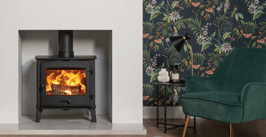 Stovax County 8 log burner shown with a bold floral print wallpaper.
