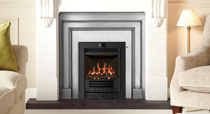 Logic Convector conventional flue fire (Slide control) with Winchester front. Shown with Victorian Corbel stone mantel, Belgravia Polished Cast Front and Insert panel.