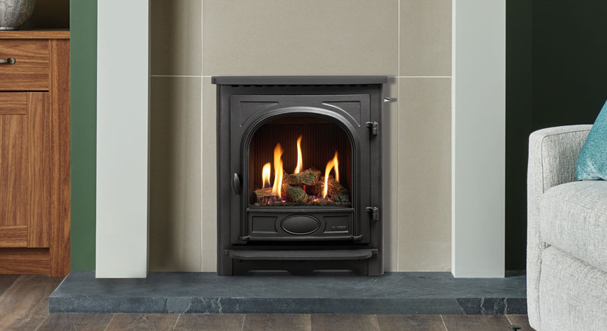 Gazco Logic™ HE Balanced flue fire with Log-effect fuel bed, shown with Stockton front and Slide control.