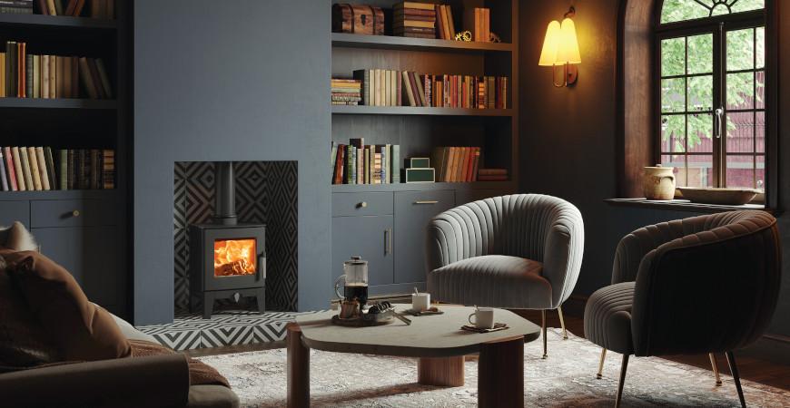 A cosy lamplit room with armchairs, built-in bookshelves and a log burner