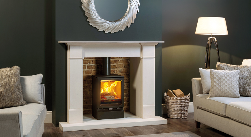 Stovax Vogue Midi wood burning and multi-fuel stove with Plinth and Claremont Limestone mantel.