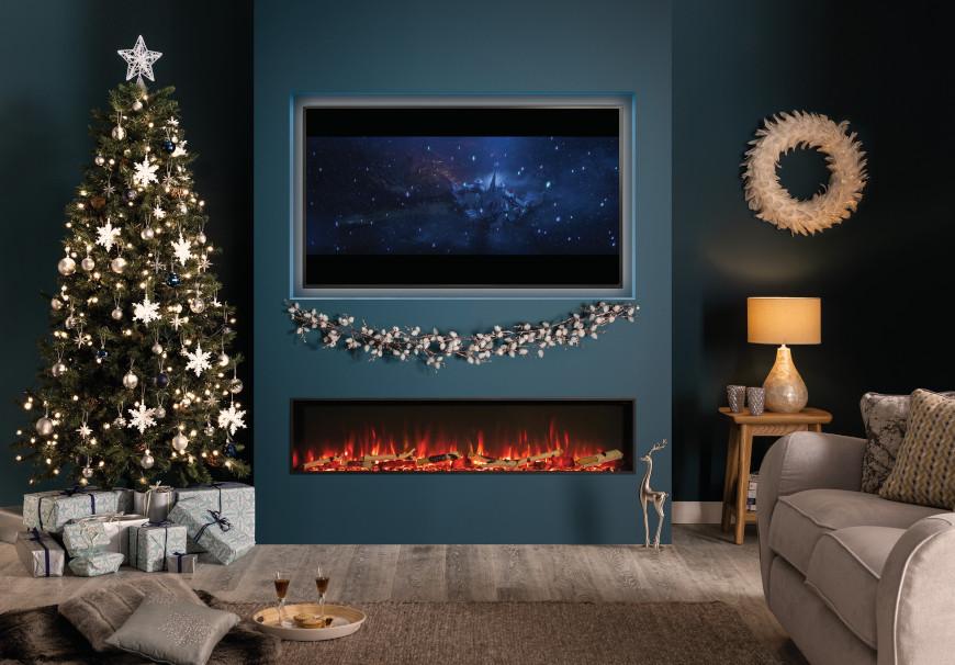 A living room decorated for Christmas, with a stunning media wall boasting a large inset electric fire.